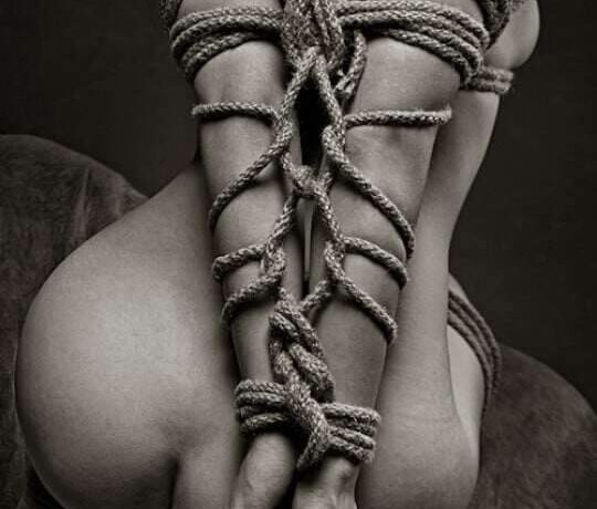 Photo of rear of naked rope bound woman